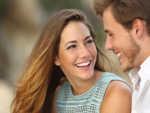 Funny couple laughing with a white perfect smile