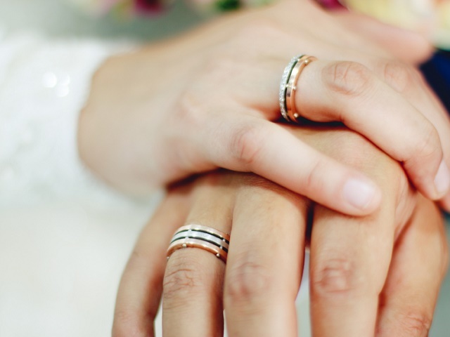 hands of a bride and groom with wedding rings