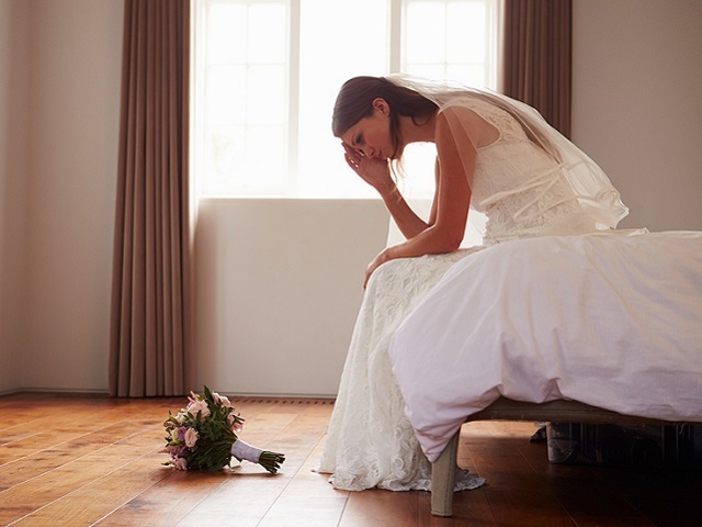 Bride In Bedroom Having Second Thoughts Before Wedding