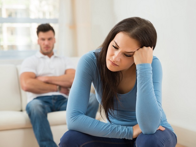 Defocused Man In Front Of Sad Young Woman